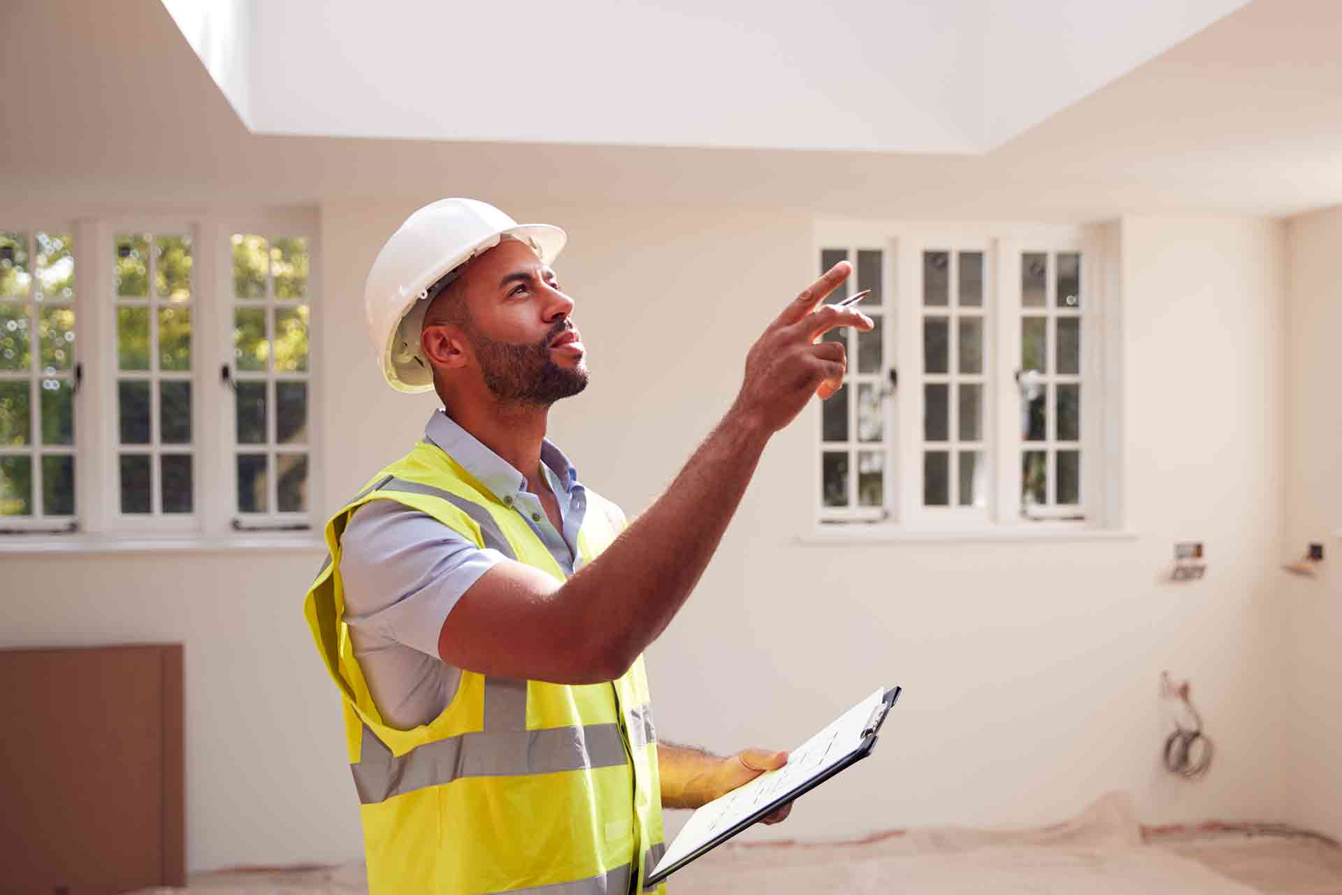Third Party Wall Surveyors Luton reviewing plans between two parties during a dispute